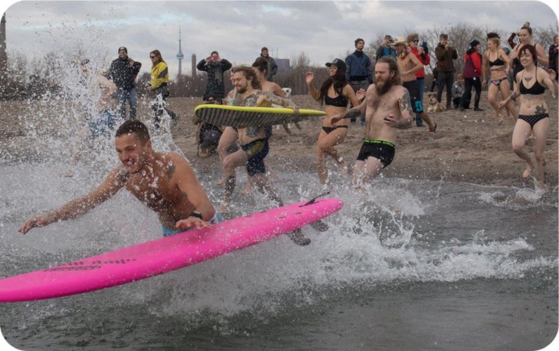 Brainfreeze participants jumping into the freezing cold lake